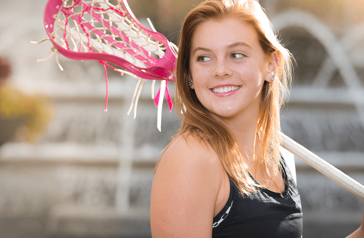 Orthodontic Patient holding lacrosse stick