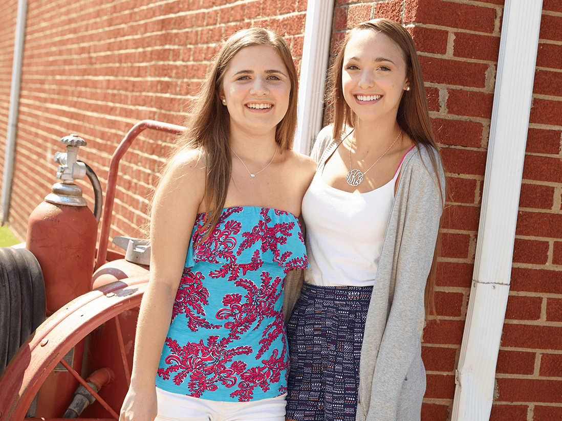 Orthodontic practice patients standing at brick wall