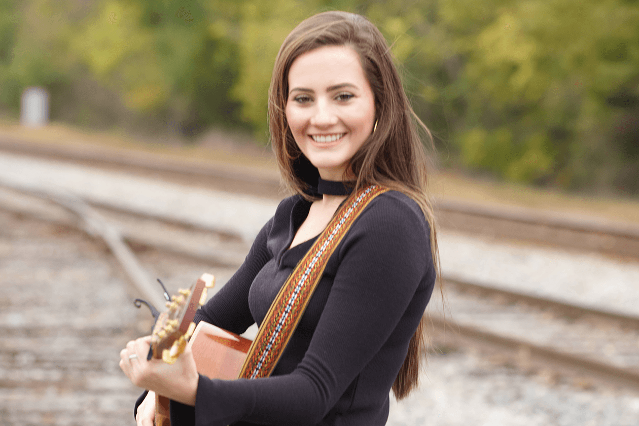 Guitar Player in front of train tracks