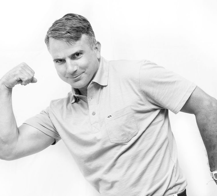A black and white photo of Dr. Bo doing a bicep curl.