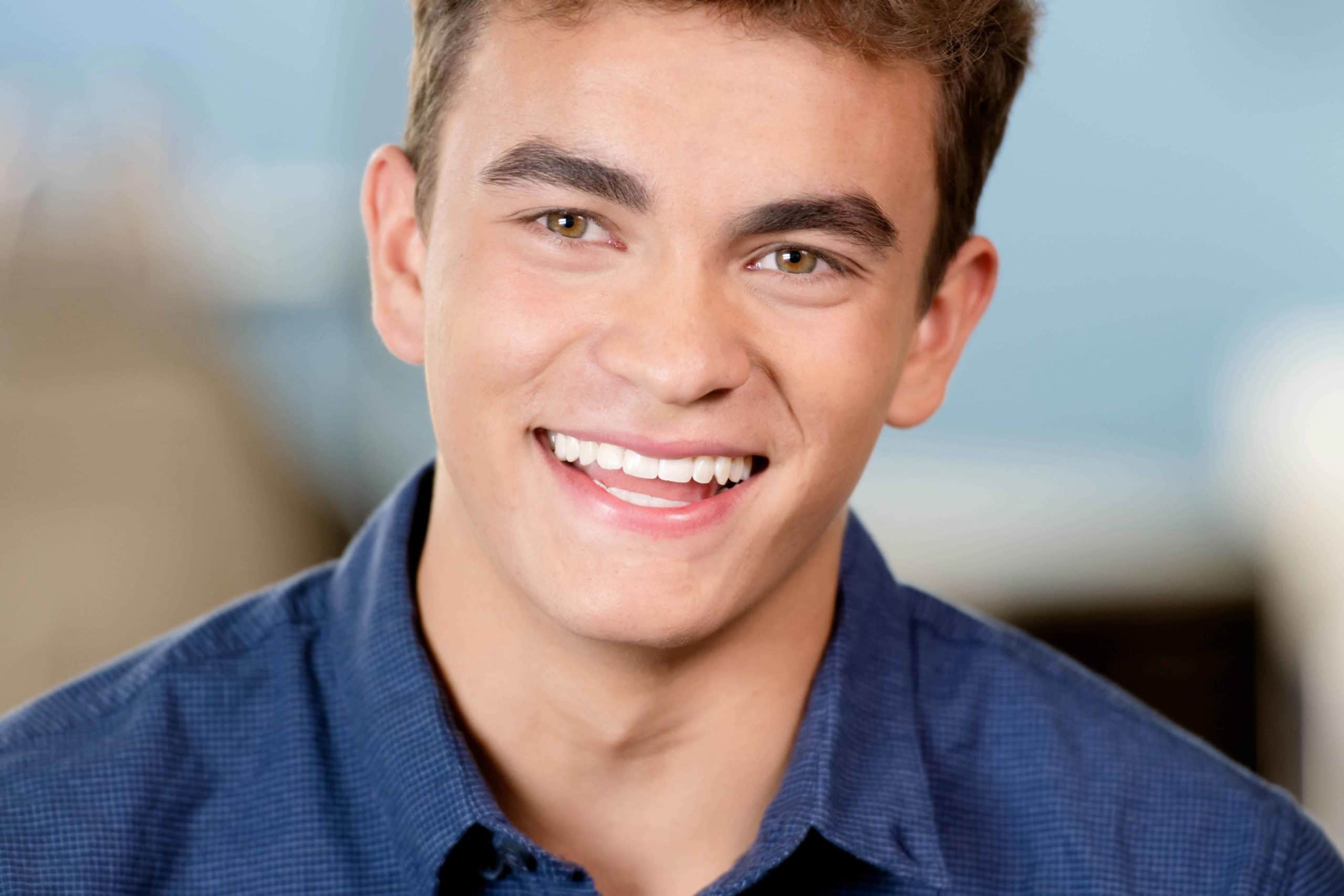 A smiling teen boy with brown hair.